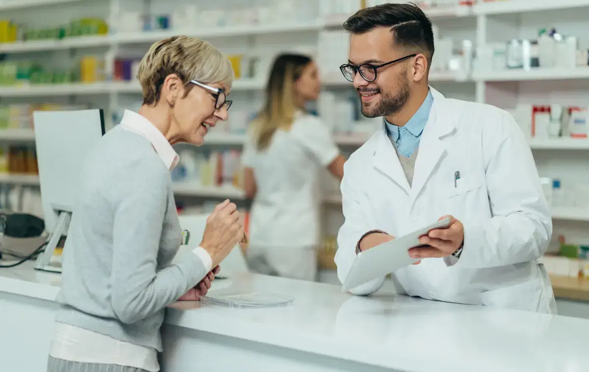 Pharmacy staff assisting a patient
