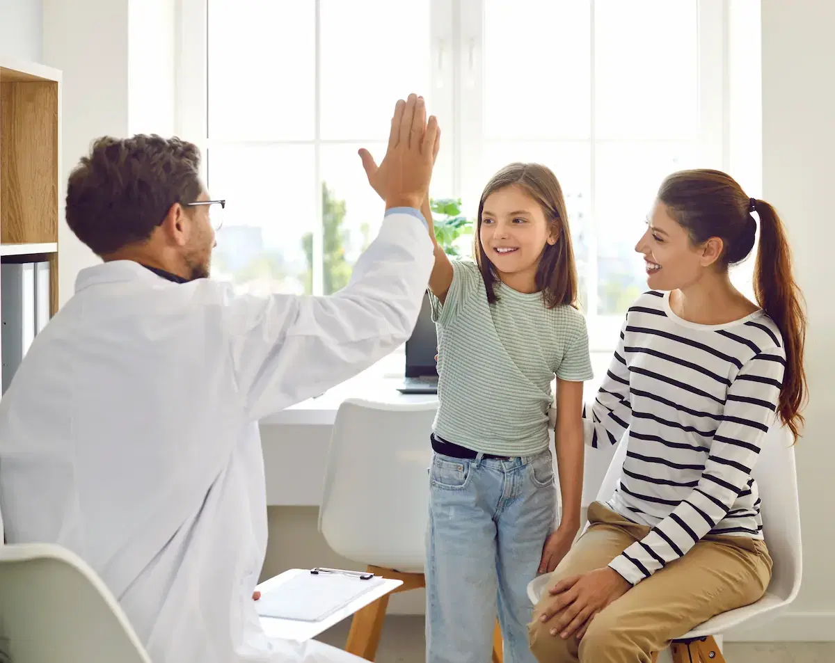 Pediatrician with patient and parent