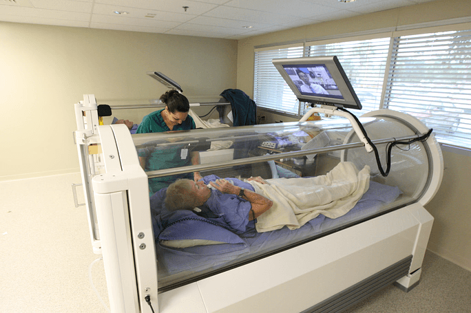 Patient with doctors providing wound care treatment